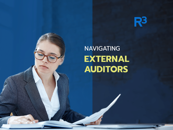 A woman in business attire reviews documents at a desk. Text reads, Navigating Compliance Audits and External Auditors, with the R³ logo in the top right corner on a blue background.