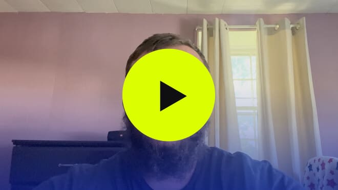 a video with a green play button in the middle