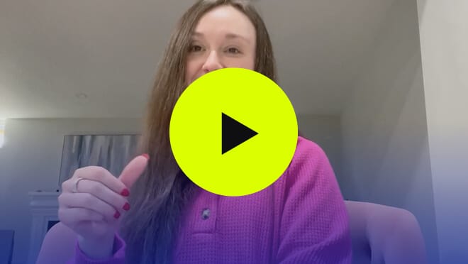a video with a green play button in the middle