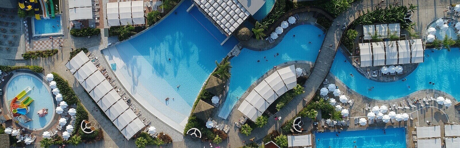 a huge tropical resort with massive pools