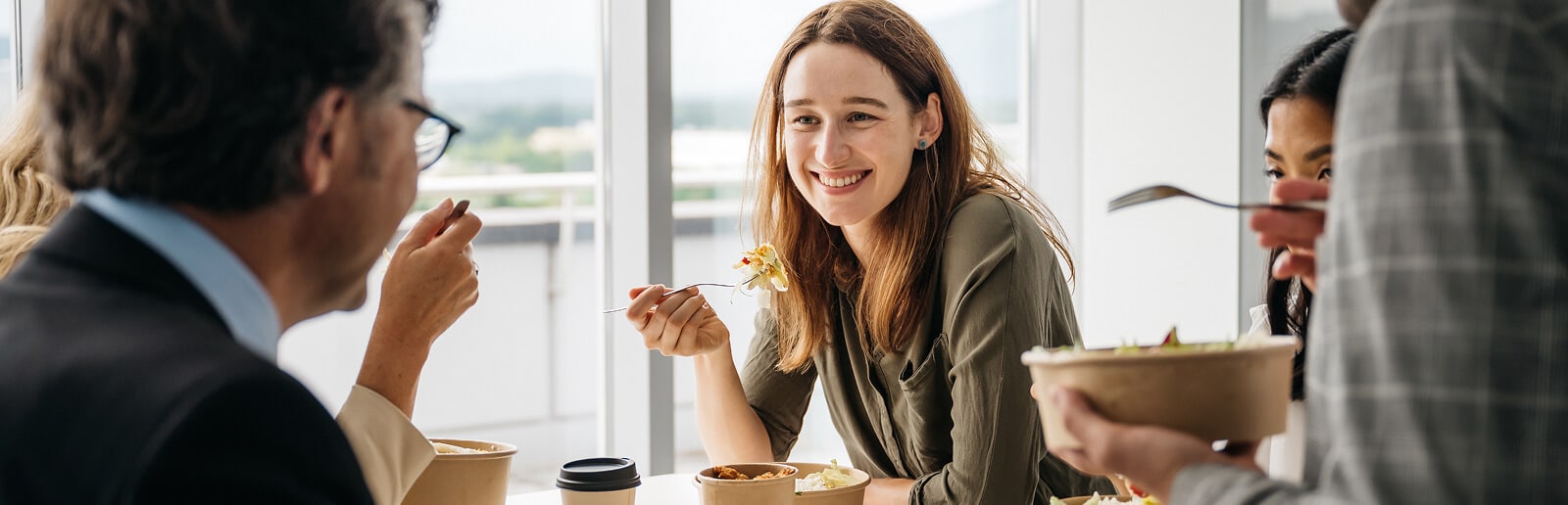 group of friends smiling having lunch together