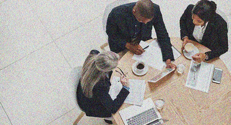 a group of people having coffee and a meeting together
