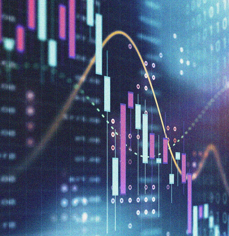 A digital screen displays colorful candlestick charts and line graphs representing financial market data, stock trading activity, and IT Asset Management insights, set against a blurred, futuristic background.