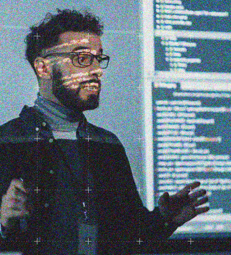 a man wearing glasses giving a presentation