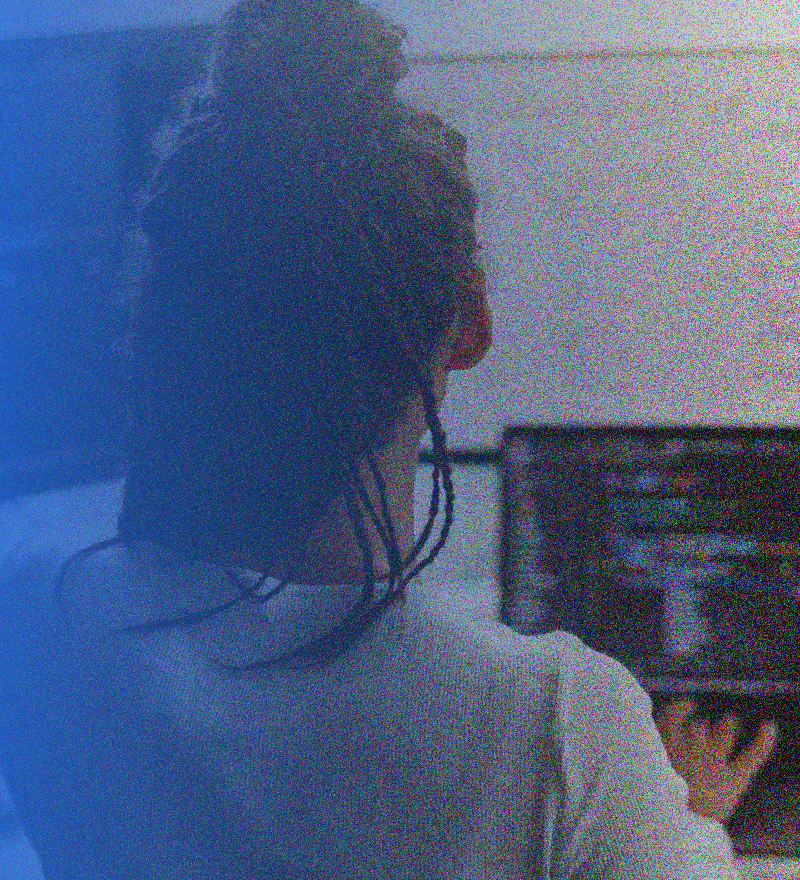 woman working on a laptop and computer on the same time