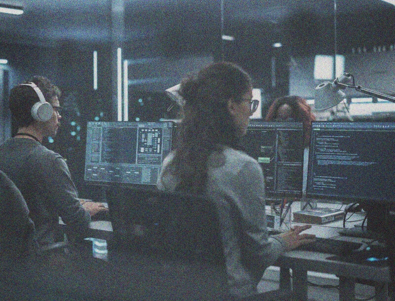 a room of people working on computers