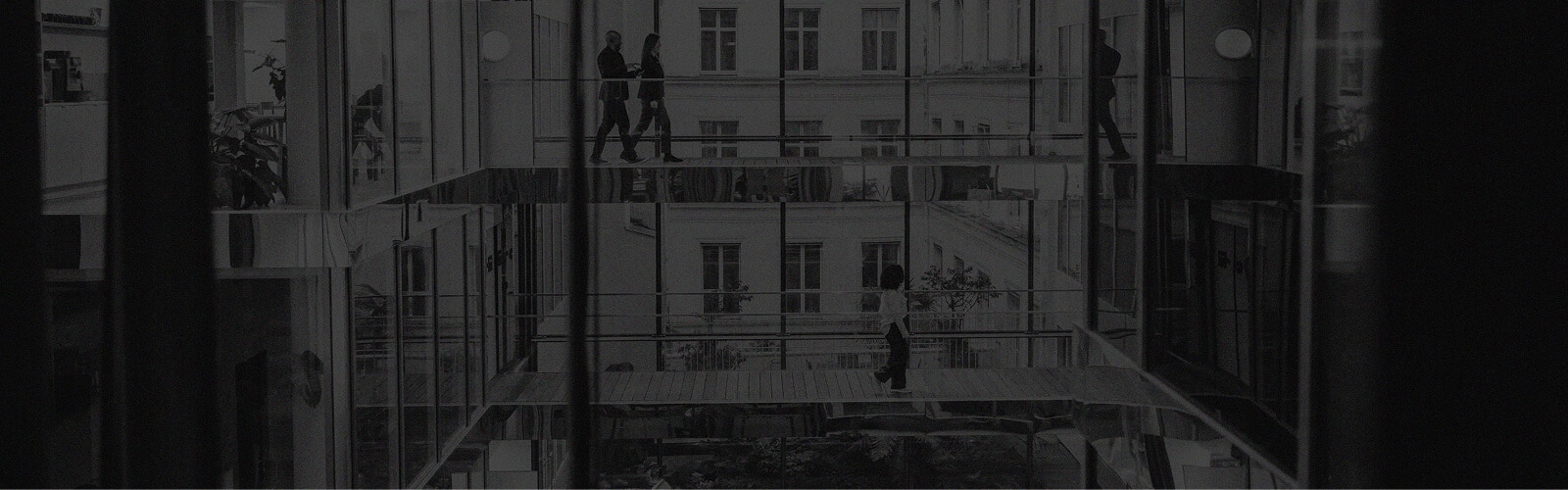people walking in a big glass building