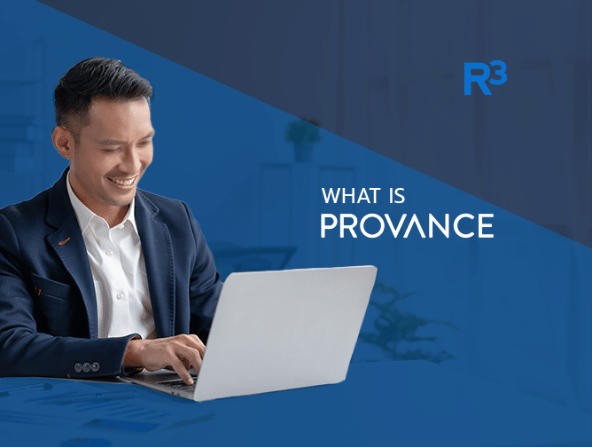 A man in a dark suit smiles while working on a laptop at a desk. The blue background features the text R³ and asks, What is Provance?.