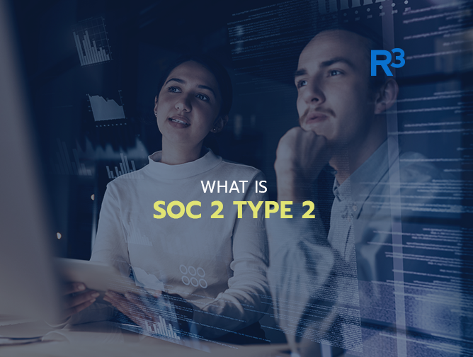 Two people look thoughtfully at computer screens with data visualizations. The overlay text says, “WHAT IS SOC 2 TYPE 2,” and the R3 logo is in the top right corner.